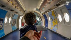 image of kid walking inside a prototype of an airplane .